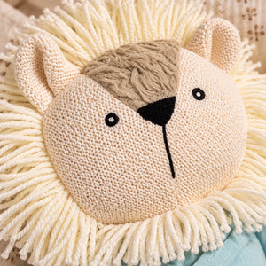 Close-up of a Cuddly Buddies Baby Simba Soft Toy or cushion with a cream rope fringed mane, beige facial fur, black nose and eyes, and a soft neutral background.