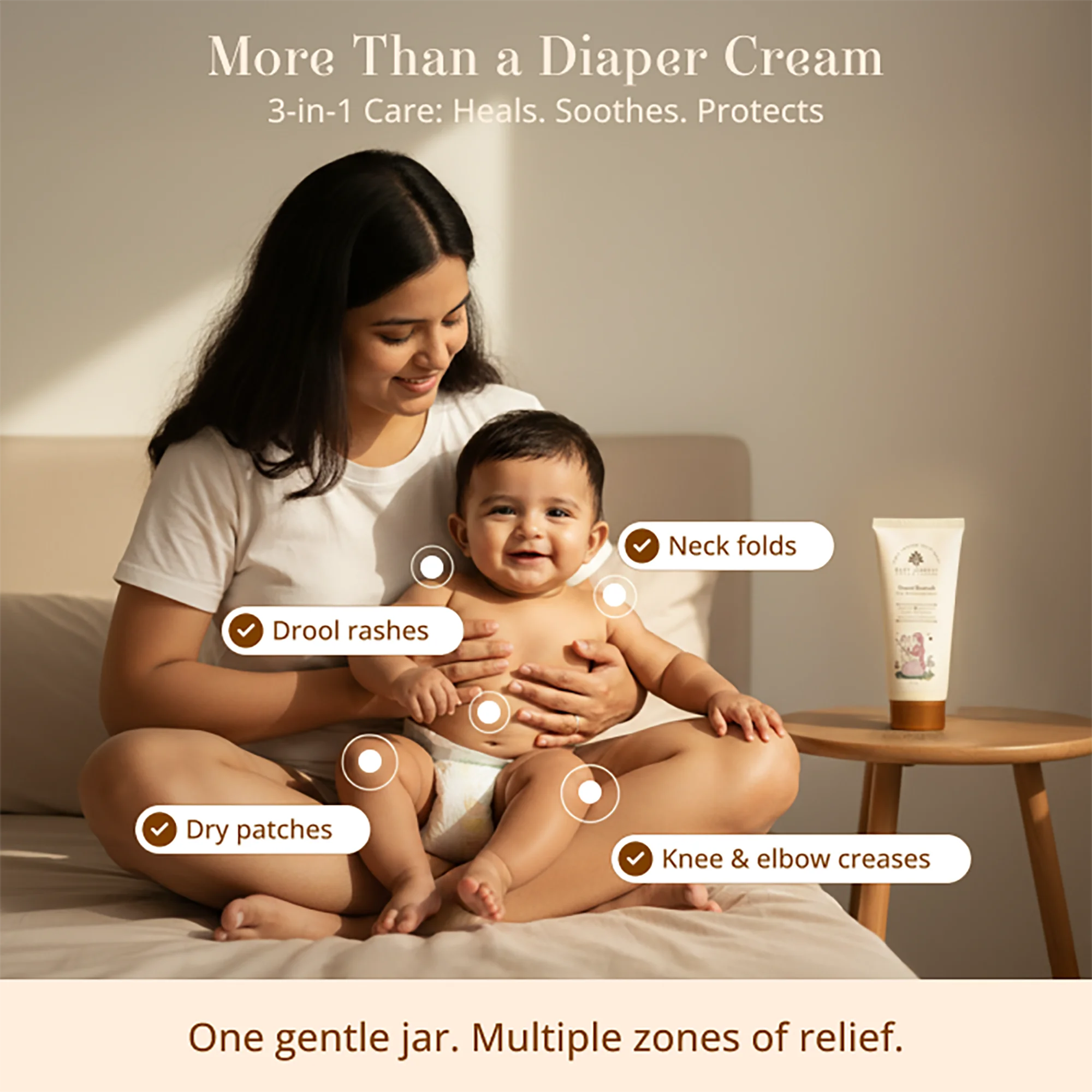A woman sitting on a bed holds a baby while promotional text and callouts explain the Komal Kawach Baby Rash Healing Cream's relief zones. 