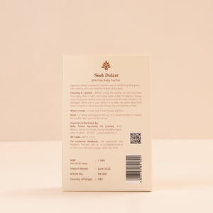 Back of a product Sneh Dulaar Baby Pacifier packaging with text and branding on a beige background