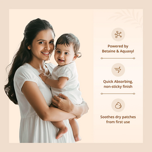 A woman holding a baby wearing white clothing, with text callouts on the right describing product benefits: powered by Betaine & Aquaxyl, quick absorbing non-sticky finish, and soothing dry patches from first use.