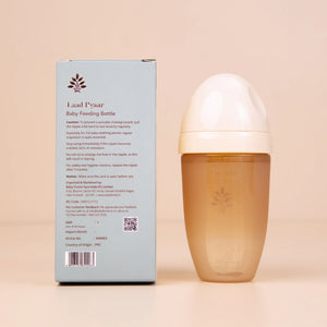 Laad Pyaar Baby Feeding Bottle with its  packaging (back side) on a beige background.