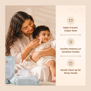 A woman in a white outfit holds a baby wearing a matching white outfit while applying a wet wipe. A package of Baby Forest Neer 99.9% Water Baby Wipes is visible in the foreground, with text on the right listing benefits: helps prevent diaper rash, soothes redness on sensitive cheeks, and is gentle for sticky hands.