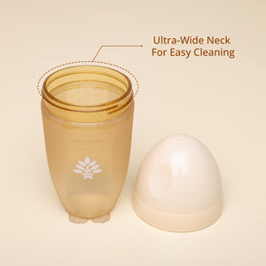 A Laad Pyaar Baby Feeding Bottle with a natural color, placed on a wooden surface.